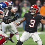 Dec 22, 2024; Atlanta, Georgia, USA; Atlanta Falcons quarterback Michael Penix Jr. (9) passes under pressure from New York Giants linebacker Kayvon Thibodeaux (5) during the first quarter at Mercedes-Benz Stadium. Mandatory Credit: Dale Zanine-Imagn Images