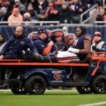 Dec 22, 2024; Chicago, Illinois, USA; Chicago Bears offensive tackle Braxton Jones (70) is carted off the field against the Detroit Lions during the second quarter at Soldier Field. Mandatory Credit: Daniel Bartel-Imagn Images