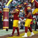Dec 22, 2024; Landover, Maryland, USA; Washington Commanders running back Jeremy McNichols (26) celebrates after scoring a two point conversion during the fourth quarter against the Philadelphia Eagles at Northwest Stadium. Mandatory Credit: Peter Casey-Imagn Images