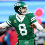 Dec 22, 2024; East Rutherford, New Jersey, USA; New York Jets quarterback Aaron Rodgers (8) drops back to pass against the Los Angeles Rams during the fourth quarter at MetLife Stadium. Mandatory Credit: Brad Penner-Imagn Images