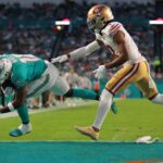 Dec 22, 2024; Miami Gardens, Florida, USA; Miami Dolphins wide receiver Tyreek Hill (10) scores a touchdown past San Francisco 49ers cornerback Charvarius Ward (7) during the second quarter at Hard Rock Stadium. Mandatory Credit: Sam Navarro-Imagn Images