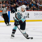 Dec 22, 2024; Denver, Colorado, USA; Seattle Kraken center Yanni Gourde (37) attempts a shot in the first period against the Colorado Avalanche at Ball Arena. Mandatory Credit: Isaiah J. Downing-Imagn Images