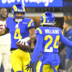 Dec 28, 2024; Inglewood, California, USA; Los Angeles Rams cornerback Ahkello Witherspoon (4) celebrates with cornerback Darious Williams (24) after an interception in the end zone against the Arizona Cardinals in the fourth quarter at SoFi Stadium. Mandatory Credit: Jayne Kamin-Oncea-Imagn Images