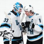 Utah Hockey Club center Clayton Keller (9) congratulates Utah Hockey Club goaltender Jaxson Stauber (33) after the Utah Hockey Club defeated the Vegas Golden Knights 6-0 at T-Mobile Arena.