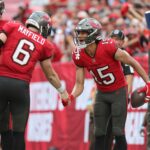 Dec 29, 2024; Tampa, Florida, USA; Tampa Bay Buccaneers wide receiver Jalen McMillan (15) is congratulated by quarterback Baker Mayfield (6) after he scored a touchdown against the Carolina Panthers during the second quarter at Raymond James Stadium.