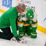 ST. PAUL, MN - DECEMBER 31: A member of the Minnesota Wild training staff tends too Minnesota Wild defenseman Jared Spurgeon (46) after he falls awkwardly into the boards during the second period of an NHL game between the Minnesota Wild and Nashville Predators on December 31, 2024, at Xcel Energy Center in St. Paul, MN. (Photo by Nick Wosika/Icon Sportswire via Getty Images)