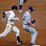 Jul 28, 2020; Houston, Texas, USA; Los Angeles Dodgers starting pitcher Walker Buehler (21) tags out Houston Astros third baseman Alex Bregman (2) during the third inning at Minute Maid Park. Mandatory Credit: Erik Williams-USA TODAY Sports