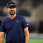 Aug 26, 2023; Arlington, Texas, USA; Dallas Cowboys offensive coordinator Brian Schottenheimer on the field before the game against the Las Vegas Raiders at AT&T Stadium. Mandatory Credit: Tim Heitman-USA TODAY Sports