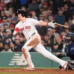 May 16, 2024; Boston, Massachusetts, USA; Boston Red Sox designated hitter Garrett Cooper (28) hits an RBI double against the Tampa Bay Rays during the fifth inning at Fenway Park. Mandatory Credit: Eric Canha-USA TODAY Sports
