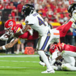 Sep 5, 2024; Kansas City, Missouri, USA; Kansas City Chiefs tight end Noah Gray (83) dives forward against Baltimore Ravens cornerback Marlon Humphrey (44) during the second half at GEHA Field at Arrowhead Stadium. Mandatory Credit: Jay Biggerstaff-Imagn Images