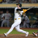 Sep 6, 2024; Oakland, California, USA; Oakland Athletics designated hitter Brent Rooker (25) hits an RBI double against the Detroit Tigers during the tenth inning at Oakland-Alameda County Coliseum. Mandatory Credit: Darren Yamashita-Imagn Images