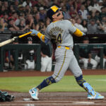 Sep 14, 2024; Phoenix, Arizona, USA; Milwaukee Brewers catcher William Contreras (24) hits an RBI sacrifice fly against the Arizona Diamondbacks in the first inning at Chase Field. Mandatory Credit: Rick Scuteri-Imagn Images - Arbitragem