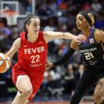 Sep 25, 2024; Uncasville, Connecticut, USA; Indiana Fever guard Caitlin Clark (22) drives to the basket defended by Connecticut Sun guard DiJonai Carrington (21) during the first half during game two of the first round of the 2024 WNBA Playoffs at Mohegan Sun Arena. Mandatory Credit: Paul Rutherford-Imagn Images