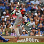 Sep 29, 2024; Chicago, Illinois, USA; Cincinnati Reds shortstop Elly De La Cruz (44) hits a two-run triple during the tenth inning against the Chicago Cubs at Wrigley Field. Mandatory Credit: Patrick Gorski-Imagn Images - MLB The Show
