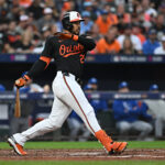 Oct 2, 2024; Baltimore, Maryland, USA; Baltimore Orioles outfielder Anthony Santander (25) hits a single in the fourth inning against the Kansas City Royals in game two of the Wild Card round for the 2024 MLB Playoffs at Oriole Park at Camden Yards. Mandatory Credit: Tommy Gilligan-Imagn Images