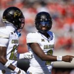 Oct 19, 2024; Tucson, Arizona, USA; Colorado Buffalos quarterback Shedeur Sanders (2) with wide receiver Travis Hunter (12) against the Arizona Wildcats at Arizona Stadium. Mandatory Credit: Mark J. Rebilas-Imagn Images
