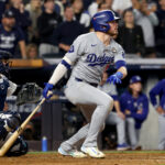 Oct 30, 2024; New York, New York, USA; Los Angeles Dodgers second baseman Gavin Lux (9) hits a RBI sacrifice fly during the eighth inning against the New York Yankees in game five of the 2024 MLB World Series at Yankee Stadium. Mandatory Credit: Vincent Carchietta-Imagn Images