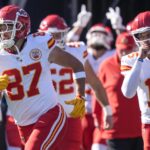 Nov 24, 2024; Charlotte, North Carolina, USA; Kansas City Chiefs tight end Travis Kelce (87) and quarterback Patrick Mahomes (15) lead their team onto the field against the Carolina Panthers during the first quarter at Bank of America Stadium. Mandatory Credit: Jim Dedmon-Imagn Images