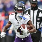 Dec 15, 2024; East Rutherford, New Jersey, USA; Baltimore Ravens wide receiver Zay Flowers (4) carries the ball against the New York Giants during the first quarter at MetLife Stadium. Mandatory Credit: Vincent Carchietta-Imagn Images