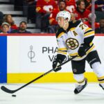 Dec 17, 2024; Calgary, Alberta, CAN; Boston Bruins defenseman Charlie McAvoy (73) controls the puck against the Calgary Flames during the third period at Scotiabank Saddledome. Mandatory Credit: Sergei Belski-Imagn Images