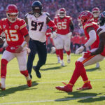 Dec 21, 2024; Kansas City, Missouri, USA; Kansas City Chiefs quarterback Patrick Mahomes (15) runs for a touchdown as Houston Texans safety Calen Bullock (21) defends during the first half at GEHA Field at Arrowhead Stadium. Mandatory Credit: Denny Medley-Imagn Images