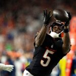 Cincinnati Bengals wide receiver Tee Higgins (5) catches a pass inside the 5-yard line as Denver Broncos cornerback Riley Moss (21) defends in overtime of the NFL game at Paycor Stadium in Cincinnati on Saturday, Dec. 28, 2024.