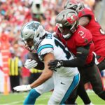 Dec 29, 2024; Tampa, Florida, USA; Carolina Panthers wide receiver Jalen Coker (18) runs with the ball as Tampa Bay Buccaneers safety Jordan Whitehead (3) defends during the first quarter at Raymond James Stadium. Mandatory Credit: Kim Klement Neitzel-Imagn Images