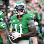 Dec 29, 2024; Philadelphia, Pennsylvania, USA; Philadelphia Eagles wide receiver A.J. Brown (11) throws the football into the stands after scoring a touchdown during the third quarter against the Dallas Cowboys at Lincoln Financial Field. Mandatory Credit: Eric Hartline-Imagn Images