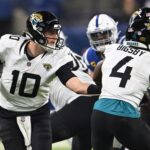 Jan 5, 2025; Indianapolis, Indiana, USA; Jacksonville Jaguars quarterback Mac Jones (10) hands then all off to Jacksonville Jaguars running back Tank Bigsby (4) during the second half against the Indianapolis Colts at Lucas Oil Stadium. Mandatory Credit: Marc Lebryk-Imagn Images