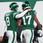 Jan 5, 2025; East Rutherford, New Jersey, USA; New York Jets quarterback Aaron Rodgers (8) and wide receiver Davante Adams (17) celebrate after a touchdown during the second half against the Miami Dolphins at MetLife Stadium. Mandatory Credit: Vincent Carchietta-Imagn Images