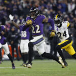 Jan 11, 2025; Baltimore, Maryland, USA; Baltimore Ravens running back Derrick Henry (22) runs for a touchdown against Pittsburgh Steelers cornerback Joey Porter Jr. (24) in the third quarter in an AFC wild card game at M&T Bank Stadium. Mandatory Credit: Geoff Burke-Imagn Images