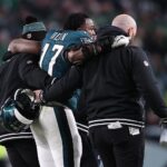 Jan 12, 2025; Philadelphia, Pennsylvania, USA; Philadelphia Eagles linebacker Nakobe Dean (17) is helped off the field against the Green Bay Packers during the first half in an NFC wild card game at Lincoln Financial Field. Mandatory Credit: Bill Streicher-Imagn Images