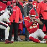 Jan 18, 2025; Kansas City, Missouri, USA; Kansas City Chiefs quarterback Patrick Mahomes (15) slides against Houston Texans linebacker Henry To'oTo'o (39) during the fourth quarter of a 2025 AFC divisional round game at GEHA Field at Arrowhead Stadium. Mandatory Credit: Denny Medley-Imagn Images
