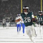 Jan 19, 2025; Philadelphia, Pennsylvania, USA; Philadelphia Eagles running back Saquon Barkley (26) carries the ball to score a touchdown against the Los Angeles Rams in the second half in a 2025 NFC divisional round game at Lincoln Financial Field. Mandatory Credit: Eric Hartline-Imagn Images