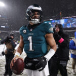 Jan 19, 2025; Philadelphia, Pennsylvania, USA; Philadelphia Eagles quarterback Jalen Hurts (1) looks on from the field after defeating the Los Angeles Rams in a 2025 NFC divisional round game at Lincoln Financial Field. Mandatory Credit: Bill Streicher-Imagn Images