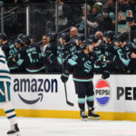 Jan 30, 2025; Seattle, Washington, USA; Seattle Kraken defenseman Brandon Montour (62) celebrates with the bench after scoring a goal against the San Jose Sharks during the second period at Climate Pledge Arena. Mandatory Credit: Steven Bisig-Imagn Images