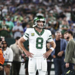 Aaron Rodgers EAST RUTHERFORD, NEW JERSEY - SEPTEMBER 11: Aaron Rodgers #8 of the New York Jets looks on prior to a game against the Buffalo Bills at MetLife Stadium on September 11, 2023 in East Rutherford, New Jersey. (Photo by Michael Owens/Getty Images)