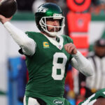 EAST RUTHERFORD, NEW JERSEY - JANUARY 5: Quarterback Aaron Rodgers #8 of the New York Jets rolls out to pass the ball in the game between the Miami Dolphins against the New York Jets at MetLife Stadium on January 5, 2025 in East Rutherford, New Jersey. (Photo by Al Pereira/Getty Images)