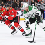 Jan 13, 2024; Chicago, Illinois, USA; Dallas Stars forward Tyler Seguin (91) controls the puck while being defended by Chicago Blackhawks defenseman Seth Jones (4) in the second period at United Center. Mandatory Credit: Jamie Sabau-USA TODAY Sports