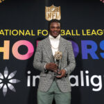 Feb 8, 2024; Las Vegas, NV, USA; NFL; Baltimore Ravens quarterback Lamar Jackson poses with the most valuable player trophy during the Pro Football Hall of Fame Class of 2024 press conference at the Resorts World Theatre