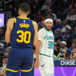 Feb 23, 2024; San Francisco, California, USA; Charlotte Hornets guard Seth Curry (right) talks with Golden State Warriors guard Stephen Curry (left) during the fourth quarter at Chase Center.