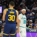 Feb 23, 2024; San Francisco, California, USA; Charlotte Hornets guard Seth Curry (right) talks with Golden State Warriors guard Stephen Curry (left) during the fourth quarter at Chase Center.