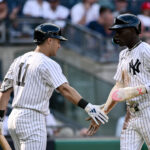 Aug 10, 2024; Bronx, New York, USA; New York Yankees third baseman Jazz Chisholm Jr. (13) is greeted at home plate by New York Yankees shortstop Anthony Volpe (11) after scoring on a RBI single by New York Yankees second baseman Gleyber Torres (not pictured) during the second inning against the Texas Rangers at Yankee Stadium. Mandatory Credit: John Jones-USA TODAY Sports Jazz Chisholm Jr.