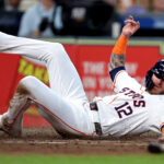 Sep 7, 2024; Houston, Texas, USA; Houston Astros right fielder Ben Gamel (12) slides across home plate to score a run against the Arizona Diamondbacks during the fourth inning at Minute Maid Park. Mandatory Credit: Erik Williams-Imagn Images