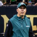 Sep 22, 2024; New Orleans, Louisiana, USA; Philadelphia Eagles offensive coordinator Kellen Moore looks on during warmups before the game against the New Orleans Saints at Caesars Superdome. Mandatory Credit: Stephen Lew-Imagn Images