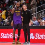 Dec 6, 2024; Atlanta, Georgia, USA; Los Angeles Lakers forward LeBron James (23) talks to head coach JJ Redick against the Atlanta Hawks in the second quarter at State Farm Arena.