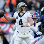 Dec 8, 2024; East Rutherford, New Jersey, USA; New Orleans Saints quarterback Derek Carr (4) drops back to pass against the New York Giants during the third quarter at MetLife Stadium. Mandatory Credit: Brad Penner-Imagn Images