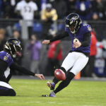 Jan 4, 2025; Baltimore, Maryland, USA; Baltimore Ravens place kicker Justin Tucker (9) kicks off as punter Jordan Stout (11) holds during the first quarter against the Cleveland Browns at M&T Bank Stadium. Mandatory Credit: Tommy Gilligan-Imagn Images