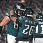 Jan 26, 2025; Philadelphia, PA, USA; Philadelphia Eagles running back Saquon Barkley (26) celebrates his touchdown with offensive tackle Lane Johnson (65) against the Washington Commanders in the NFC Championship game at Lincoln Financial Field. Mandatory Credit: Eric Hartline-Imagn Images - Super Bowl Eagles TPO
