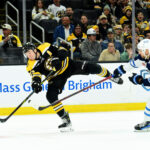 Jan 30, 2025; Boston, Massachusetts, USA; Boston Bruins defenseman Charlie McAvoy (73) shoots the puck while Winnipeg Jets right wing Nino Niederreiter (62) defends during the third period at TD Garden. Mandatory Credit: Bob DeChiara-Imagn Images